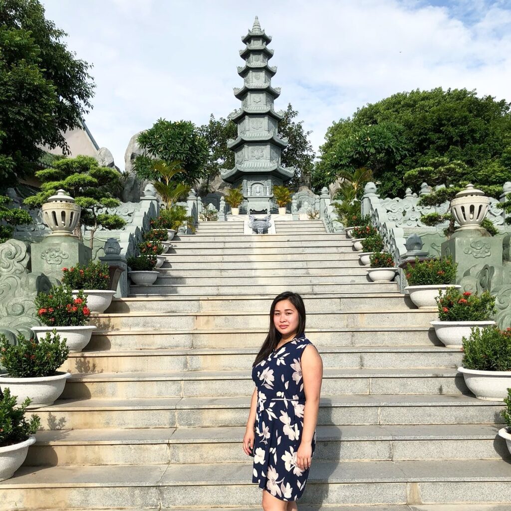 Mai in front of a temple